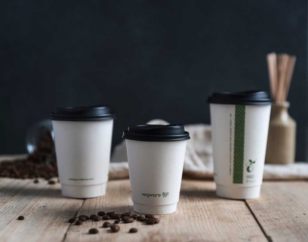 Vegware's white double wall cups and lids lined up on a table