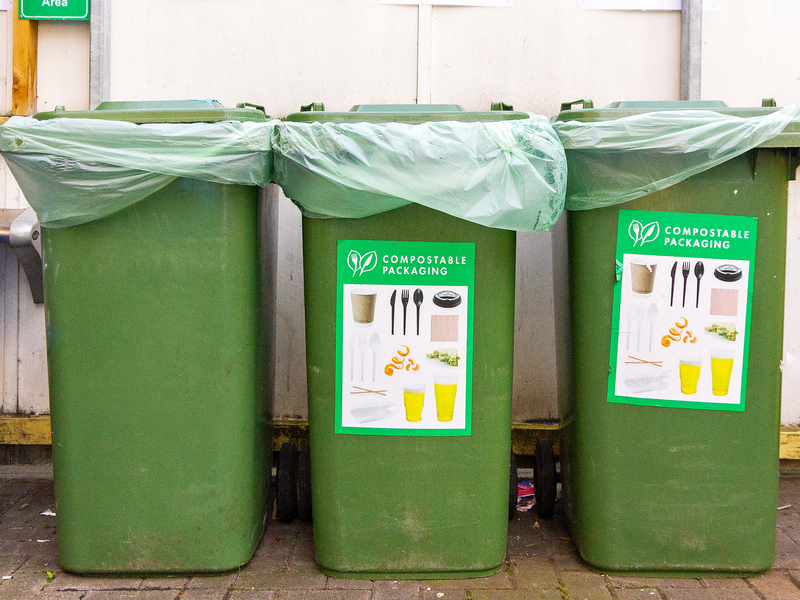 Three bins in a row for Vegware and food waste composting collections